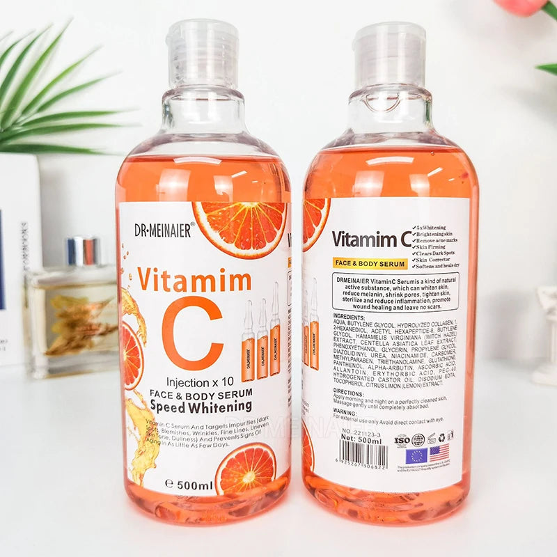 Two bottles of Dr. Meinauer Vitamin C serum on a white surface with a blurred background.